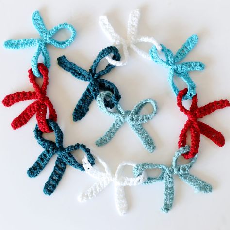 Crochet Bow Garland (with giveaway!) - Sugar Bee Crafts Crochet Hanging Garland, Crochet Ribbon Garland, Simple Crochet Garland, Bow Garland Crochet, Crochet Valentines Garland, Crochet Bow Garland Free Pattern, Crochet Birthday Decorations, Crochet Bow Garland, Crochet Christmas Decorations Free Pattern