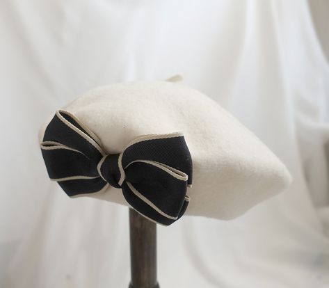 Introducing our elegant white beret with a stylish twist! This delightful accessory features a charming black bow on the side, adding a touch of sophistication to any outfit. Perfect for any occasion, whether it's a special event or a casual day out, this white beret with a black bow is a versatile addition to your wardrobe. Elevate your style and grab everyone's attention with this unique and fashionable accessory. Treat yourself or surprise a loved one with this chic beret today! Material: 100 Beret With Bow, Black Zip Up Hoodies, Lace Beret, White Beret, Wool Berets, Berets, French Inspired, Black Bow, Fashion History