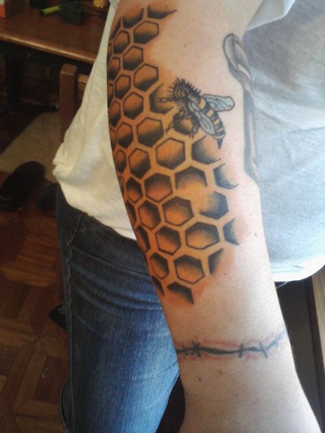 This is my honey comb and bee tattoo. that was done in one sitting, I go back to add apple blossoms around it. <3 Honey Comb Elbow Tattoo, Honey Comb Sleeve Tattoos, Bee And Honeycomb Tattoo Sleeve, Honey Comb Tattoo Men, Bee Tattoo Behind Elbow, Queen Bee Tattoo, Honeycomb Tattoo, Hexagon Tattoo, Honeybee Art