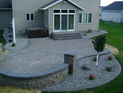 Earth Tone Paver Patio with Sitting Wall and Rock Fill Edging - Oasis Landscapes Patio Step Down To Lawn, Step Down Patio Ideas, Midwest Backyard, Landscaping Around Patio, Patio Extension, Sitting Wall, Paver Patterns, Paver Patios, Plants Landscape