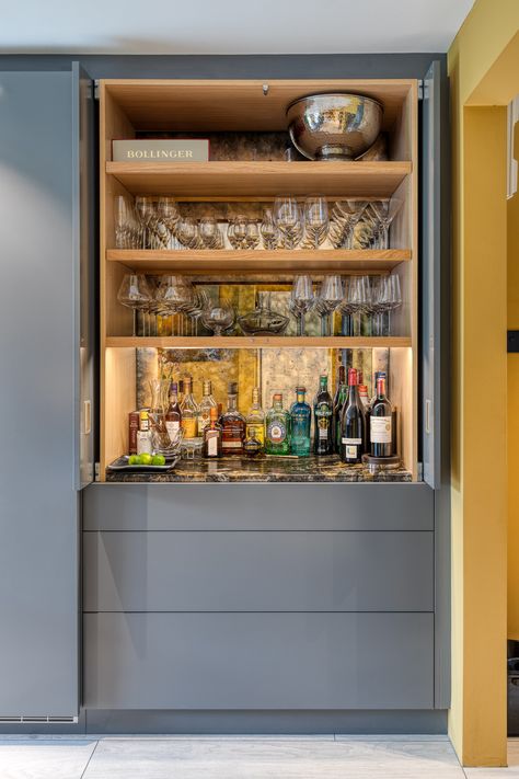 Beautiful hand built Drinks Cabinet is a feature of this contemporary, handleless kitchen. The Antiqued Mirror backing glass and Black Granite worktop give it drama and elegance. Small Built In Bar, Contemporary Home Bar Designs, Built In Bar Cabinet, Conservatory Kitchen, Home Bar Cabinet, Home Bar Rooms, Modern Home Bar, Bar In Casa, Bar Sala