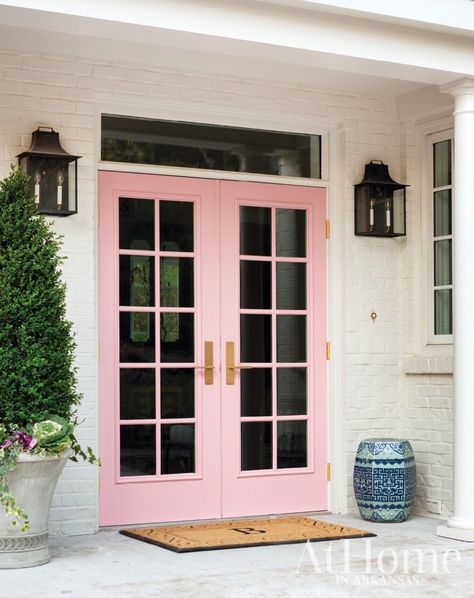 French doors painted a happy pink hue against a white brick exterior offer an informal, welcoming entrance for visitors. French Doors Living Room, French Doors With Screens, French Doors Bedroom, Pink Front Door, French Door Curtains, Black Interior Doors, French Doors Patio, Pink Door, Built In Furniture