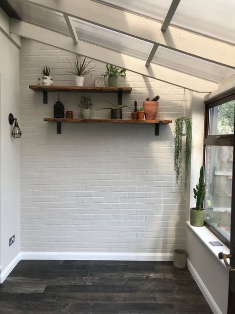 #conservatory #renovation #boho #woodeffecttiles #paintedbrickwalls #paintedbrick #kerakoll #kerakolldesignhouse #scaffoldshelves #scaffoldshelf Brick Painting Interior, Painted Brick Sunroom, Painted Brick Conservatory Interior, White Brick Sunroom, Brick Conservatory Ideas, Bricks Painted White Interior, Brick Wall Sunroom, Exposed White Brick Wall, White Brick Interior Wall