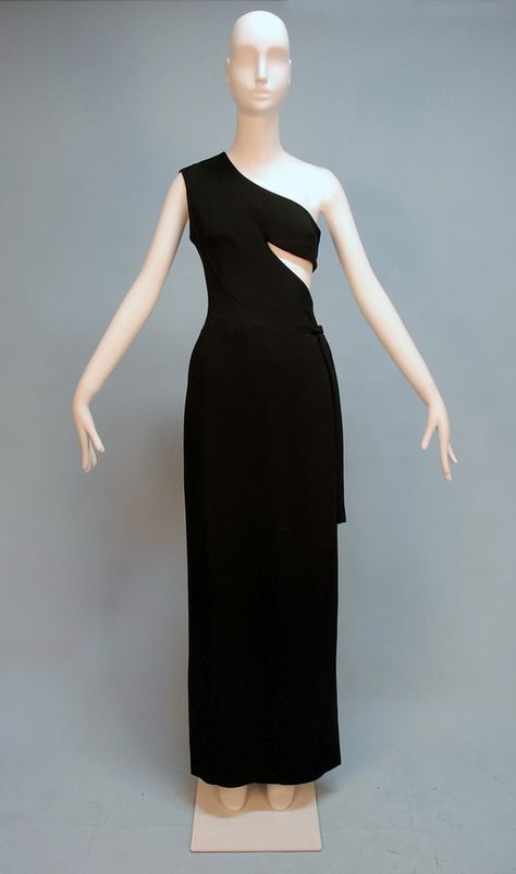 MADAME GRES ASYMMETRICAL ONE-SHOULDER GOWN, c. 1970. Black rayon faille wrap style with triangular side cutout, side self tie over hook and eye closures and snaps, Paris label. Front 1970s Vintage Fashion, Grecian Gown, Madame Gres, 20th Century Fashion, French Fashion Designers, One Shoulder Gown, Vintage Gowns, Couture Designers, Vintage Couture