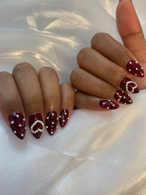 Red Nails With Pearls On Them, Burgundy Nails With Pearls, Dark Vday Nails, Dark Red Nails With Pearls, Dark Red Pearl Nails, Red Nails Pearls, Cherry Wine Nails With Design, Red And Pearl Nails, Red Nails With Stones