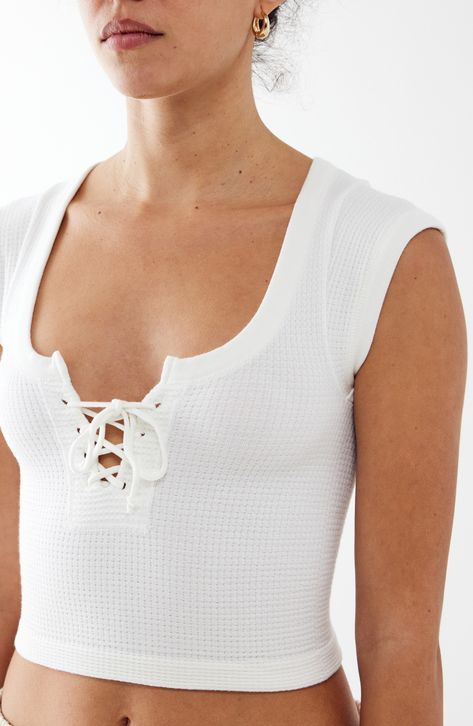 Love to layer in this close-fitting cropped tank crafted with textured waffle stitching and fronted with a laced-up neckline. Exclusive retailer 15 1/2" length Lace-up neck Sleeveless 79% modal, 15% polyamide, 6% elastane Machine wash, dry flat Made in Turkey White Short Sleeve Crop Top, Trip Fits, Clothes Preppy, Gift Wishlist, Lovely Princess, Urban Outfitters Top, Personal Things, Tropical Outfit, Closet Wishlist