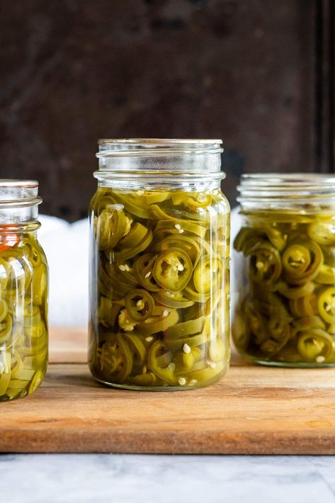 Do you love pickled jalapeños? If so, then you’re going to love this easy recipe for homemade Pickled Jalapeño Peppers. This simple recipe will have you preserving jalapeños in no time! You won't believe how easy it is to make your own delicious and spicy Pickled Jalapeno Peppers at home. They're perfect for topping burgers and hot dogs, adding a kick to sandwiches and tacos, or just snacking on right out of the jar! These tasty little guys are also great as an appetizer with cream cheese and cr Yellow Jalapeno Peppers, Preserving Jalapeños, Canning Pickles Recipe, Pickled Jalapeno Recipe, Canning Jalapeno Peppers, Pickled Things, Pickled Recipes, Burgers And Hot Dogs, Pickled Hot Peppers