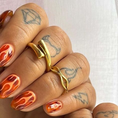 Jade Knight | Nail Artist on Instagram: "Tortie ft orange flames 🔥   Using all @dali.artistic because it’s the best in the game!  Use my code JADECREATIVE to save 😍😍😍   @bohomoon  use my code to save 💰 BYJAY10  #tortie #tortienailart #flames #flamenails #showscratch #nailitdaily #nailitmag #nailit #thesalonmaguk #orangenails #almondnails #nailsofinstagram #nailsdesign #nailinspiration #nailinspo #goldrings #bohomoon #bohomoonrings #fashion #style #stylish #nailstagram #love #obsession #" Nail Flames Design, Short Nail Designs Orange, Acrylic Nail Designs Autumn, 60s Nail Art, Bright Fall Nails, 70s Nail Designs, Masc Nails, Squiggle Nails, Realistic Nails