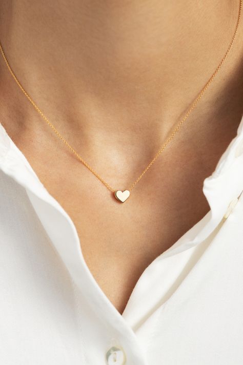 This petite gold heart pendant necklace will compliment everything from denim to little black dresses. Designed with both comfort and style in mind, this piece is perfect for everyday wear. Minimalist with a high shine finish, this small yet mighty stunner is bound to become a staple in any gal’s ensemble. Gift this symbolic piece to a loved one or better yet, gift it to yourself! Small Heart Necklace, Tiny Heart Necklace, Heart Choker Necklace, Aventurine Necklace, Pendant Necklace Simple, Double Heart Necklace, Diamond Cross Necklaces, Heart Choker, Heart Pendant Gold