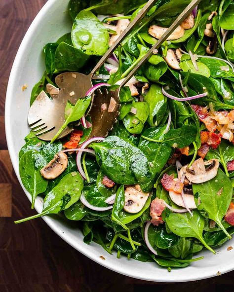 Spinach salad with hot bacon dressing combines baby spinach, crispy bacon, sliced red onion, and mushrooms tossed together with a hot honey Dijon bacon dressing. This salad is a hit at gatherings but is equally great for weeknights at home. #spinachsalad #spinachandbaconsalad #saladrecipes Hot Spinach Salad With Bacon, Warm Spinach Salad With Bacon, Wilted Spinach Salad With Bacon Dressing, Spinach Mushroom Salad, Spinach Salad Dressing Vinaigrette, Spinach Salad With Hot Bacon Dressing, Warm Bacon Dressing For Spinach Salad, Hot Bacon Dressing For Spinach Salad, Spinach Salad With Warm Bacon Dressing