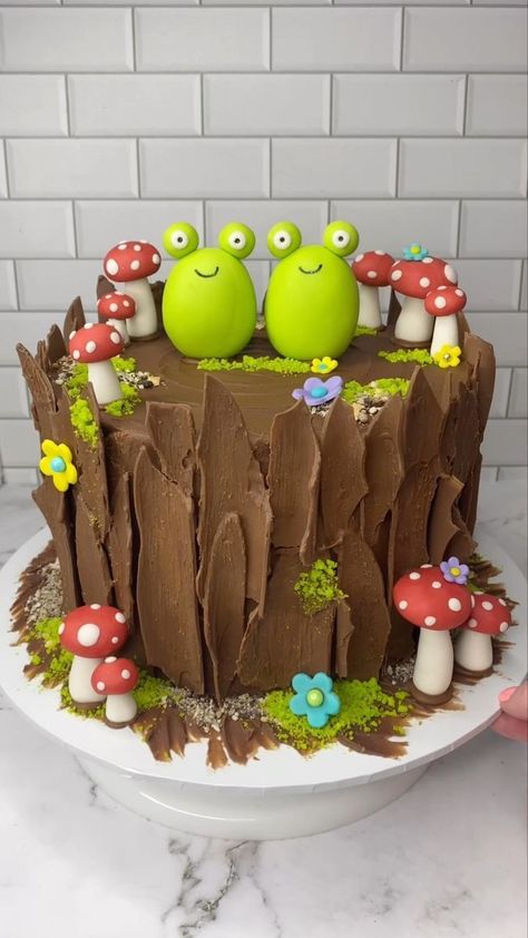 Yes…… yes I am 🐸❤️🐸 🐸 Obsessed with frog cakes 🐸 I made all the decorations with fondant (🐸🍄🌸) and I followed the lovely @sheri_wilson_ tutorial to make the tree bark. It’s so easy to follow and looks so real 💚 My kids asked for a “frogs on a log” cake and this is what I made them. Their little faces when they saw it…. priceless ❤️ #cakedecorating #enchantedforest #frogcake #cakeart #cakedesign #bakinginspo #cakedbyrach | Caked By Rach | Easy Frog Cake, Frog Cake Ideas, Fondant Frog, Woodsy Cake, Frogs On A Log, Frog Birthday Cake, Enchanted Forest Cake, Sheri Wilson, Mushroom Birthday