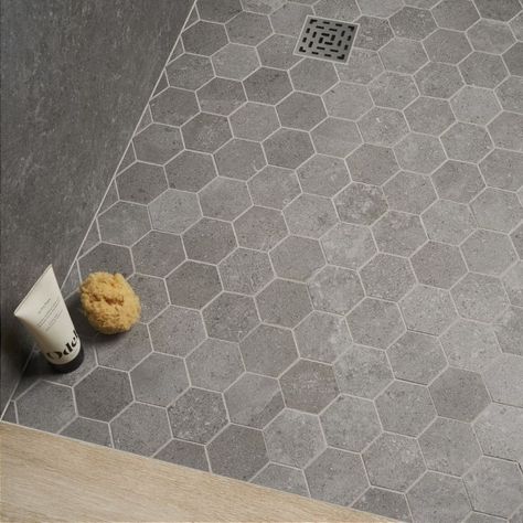 New Rock Fossil Dark Gray 2" Hex Matte Porcelain Mosiac | Tilebar.com Dark Grey Tile Bathroom, Gray Hexagon Tile, Hexagon Tile Bathroom Floor, Grey Stone Tiles, Penny Tiles Bathroom, Hexagon Tile Bathroom, Gray Shower Tile, Grey Mosaic Tiles, Dark Grey Tile