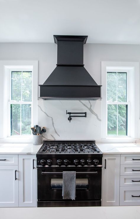 Black Hood With White Cabinets, White Kitchen With Black Island And Hood, Black Exhaust Hood Kitchen, Black Stove Kitchen Ideas, Black Hood Over Range, Black Hood Range White Cabinets, Black Hood White Cabinets, White Cabinets Black Hood, Black Hood Vents Kitchen