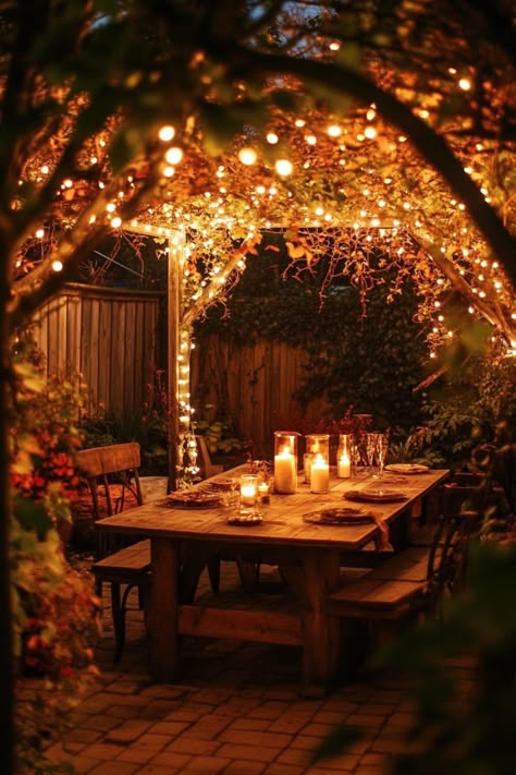 Cozy outdoor dining area under a pergola adorned with string lights and candles. Backyard Landscaping Texas, Renter Friendly Backyard Ideas, Backyard Ideas For Renters, Backyard Australia, Cozy Backyard Ideas, Apartment Backyard, Backyard Hosting, Whimsical Backyard, Creative Backyard Ideas