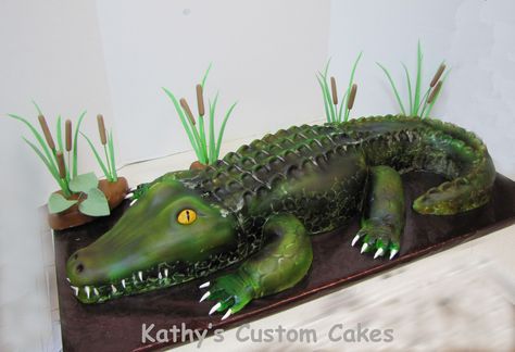 Louisiana Alligator Cake - This was the first cake I made using my new airbrush machine.  I learned a valuable lesson....airbrush doesn't stick to shortening.  I used shortening on my impression mat and the seams.  I should have brushed the whole thing down with powdered sugar before airbrushing.  Still, he came out pretty awesome.  He was almost 3 feet long.  I made this for a little boy's 10th birthday.   I added a picture of what it looked like cut, that is always neat to see.  For ... Crocodile Cake, Alligator Cake, Gator Party, Africa Cake, Louisiana Alligator, Alligator Party, Alligator Birthday, Airbrush Machine, Realistic Cakes