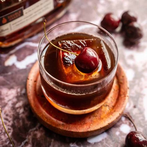 This spiced cherry old fashioned is a cherry spin on the traditional old fashioned and combines cherries, brown sugar, and cinnamon and transforms it into a very drinkable bourbon cocktail! Spiced Cherry Old Fashioned, Smoked Cherry Old Fashioned, Espresso Old Fashioned Cocktail, Cherry Bounce Cocktail, Cherry Whiskey Drinks, Cherry Old Fashioned Cocktail, Cherry Bourbon Cocktail, Cherry Old Fashioned, Lavender Cocktails