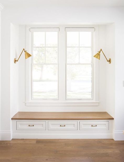 Boston Functional Library Lights illuminate a mudroom window seat nook with a wood top bench and three shaker drawers fitted with brass pulls. Mudroom Window, The Fox Group, Window Seat Nook, Fox Group, Transitional Laundry Room, Window Bench Seat, Window Mudroom, Window Seat Design, Seat Bench