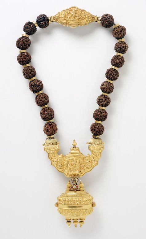 Gowrisangam. Necklace with Shiva's Family India, Tamil Nadu, late 19th century Jewelry and Adornments Gold inlaid with rubies and a diamond; Rudraksha (eye of Rudra/Shiva) beads (elaeo carpus seeds); silver back plate on clasp Rudraksha Jewelry, Rudra Shiva, Rudraksha Mala, Canada Fashion, Mens Pendant, Royal Jewelry, Tamil Nadu, Temple Jewellery, Traditional Jewelry