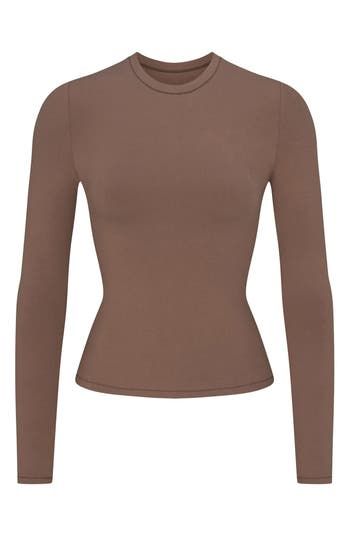 A tried-and-true classic, this fitted long-sleeve T-shirt cut from stretch-enhanced cotton jersey is from Kim Kardashian's highly sought-out SKIMS collection. 21" regular length (size Medium) Crewneck Long sleeves 90% cotton, 10% elastane Machine wash, tumble dry Imported T Shirt Cut, Jersey Long Sleeve, Cut Tshirt, Shirt Long Sleeve, Cut Shirts, Kim Kardashian, Stretch Cotton, Cotton Tee, Long Sleeve T Shirt