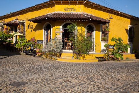 Picture of Traditional house with flowers on the corner of two streets in Suchitoto - El Salvador - Americas Salvador House, House With Flowers, Stone Street, Yellow House, Yellow Houses, On The Corner, Exploring The World, Booking Hotel, Travel Stories