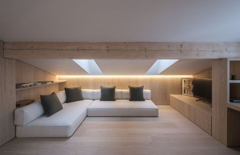 Designing an Attic Room With Slanted Eaves Low Ceiling Attic Living Room, Low Ceiling Attic Storage, Room Ideas With A Slanted Roof, Attic Media Room Sloped Ceiling, Attic Tv Room, Sloping Roof Bookshelf, Slant Ceiling, Master Attic Bedroom Ideas Angled Ceilings, Opening Atic For Storage