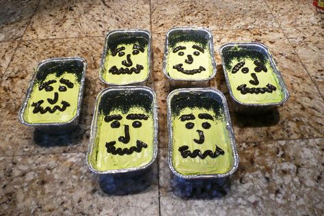 I made chocolate cakes in mini loaf pans for a school cake walk. I made them into Frankenstein faces. I used black sugar (hair), white frosting tinted green (skin) and then used chocolate frosting tinted it black for the face. I got 6 loafs from a standard box cake mix. They were very popular at the event. Halloween Mini Tray Cakes, Halloween Mini Loaf Cakes, Mini Loaf Cakes, Mini Loaf Pan, School Cake, White Frosting, Halloween Food Treats, Mini Loaf, Cake Walk