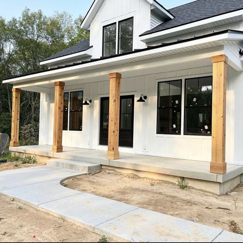 White House With Wood Posts, White Tin Siding House, Front Porch Builds, Front Porch With Metal Roof, Wood Beams Front Porch, White Exterior House With Wood Accents, White Modern Farmhouse Exterior, Farmhouse Siding, White Ranch House