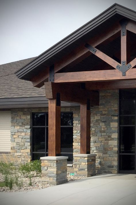 Exterior Wood Beams Entrance, Stack Stone Exterior House Front Porches, Replacing Columns With Wood Beams, Wood Features On House Exterior, Cedar Beams Exterior, Wood Beams Exterior House, Gable Roof Over Front Door, Vertical Siding With Stone, Rustic Craftsman Exterior