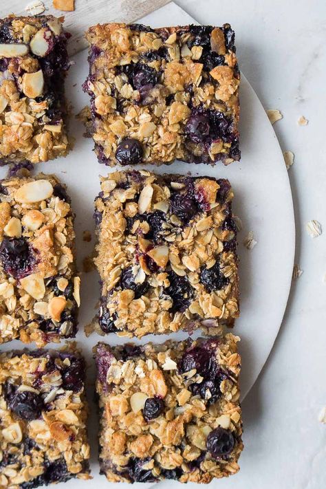 Made with rolled oats and blueberries, these healthy blueberry baked oatmeal bars are a handheld breakfast that is perfect for busy mornings. Handheld Breakfast, Lactation Muffins, Blueberry Squares, Baked Oatmeal Bars, Blueberry Baked Oatmeal, Oatmeal Bars Healthy, Breakfast Bars Recipe, Blueberry Bars, No Bake Oatmeal Bars