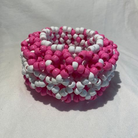 This Bright Pink and White 3D Kandi Cuff is a bold and playful piece of handmade jewelry, commonly found in the rave and EDM culture. This cuff features an eye-catching combination of bright pink and white beads, arranged in a three-dimensional pattern that adds depth and texture to the design. The vibrant pink beads exude energy and excitement, while the white beads provide a crisp contrast, highlighting the intricate 3D structure. This type of Kandi cuff is not only a statement accessory but a Big Kandi Cuff, 3d Kandi Cuff, Kandi Kids, 3d Kandi, Kandi Cuff Patterns, Rave Scene, 3d Structure, Kandi Inspo, Diy Kandi Bracelets