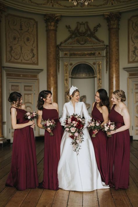 Bride in long sleeve Jesus Peiro wedding dress with large floral headband holding a pink and red rose wedding bouquet with the bridesmaids in burgundy dresses Burgandy Bridesmaids Dress, Long Sleeve Satin Wedding Dress, Red Rose Bouquet Wedding, Stowe House, Hen Party Ideas, Green Studio, Bridal Party Bouquets, Gorgeous Bridesmaid Dresses, Long Sleeve Bridal Gown