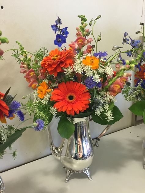 Galvanized Pitcher floral centerpiece with gerbera daisies , snap dragon , delphinium Snap Dragon, Church Decorations, Gerbera Daisies, Summer Fresh, Floral Centerpiece, Silver Decor, Gerbera Daisy, Flower Arranging, Church Decor