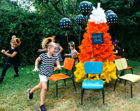 Halloween musical chairs is just like ordinary musical chairs, only played to a Halloween soundtrack and full of fun Halloween decor. As ordinary musical chairs goes, it is a blast for all ages and brings out just enough of everyone’s competitive spirit. Set up chairs around a fun tree decorated for Halloween, as designer Jennifer Perkins did here. Forest Ideas, Party Stations, Fun Halloween Party Games, Halloween Christmas Tree, Dekorasi Halloween, Halloween Party Decor Diy, Fun Halloween Games, Musical Chairs, Easy Halloween Party