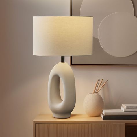 Enhance your home with the Brightech Artemis Ceramic LED Table Lamp, a sculptural piece that combines the serenity of the beach with modern elegance. This cream ceramic lamp, evoking the soft hues of sand and sea, is ideal for both bedside and living room settings, embodying a coastal, nautical charm. Its artistic design, reminiscent of seaside and maritime elements, fits seamlessly into various decor styles, from the shoreline to sophisticated urban interiors. The white ceramic base, paired wit Bed Side Table Light, Trendy Lamps For Bedroom, Modern Living Room Lamp, Modern Bedside Table Lamps, Modern Bedside Lamp, Bedroom Table Lamps, Night Stand Light, Bedroom Lamps Nightstand, Living Room Lamps