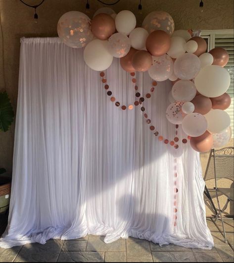 Balloon Garland On Top Of Backdrop, Balloon Garland Stage Decor, Bridal Shower Ideas Simple Decoration, Pink And White Backdrop Party Ideas, Outdoor Party Photo Backdrop, Party Decorations For Grandma, Rose Gold Backdrop Ideas, Tulle Backdrop With Balloons, Fabric Backdrop With Balloons