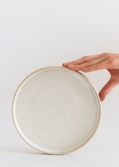 Minimal ceramic plates with a rim / edge made with fantastic speckled clay and white glossy food-safe glaze inside. Plates have minimal modern design and bright, calm look.  If you are interested in greater amount - please use this listing https://www.etsy.com/listing/1283221815/minimal-ceramic-plates-with-a-rim Plates are available in two sizes. Approx. measures  dinner size Ø = 9.4''/24 cm height = 0.8''/2cm smaller / breakfast size Ø = 7.8''/20 cm height = 0.8''/2cm Microwave and dishwasher safe. Food-safe glaze. Handmade wheel-thrown pottery. You can also complete this dinnerware with matching bowls and cups.  Plates are made on pottery wheel with fantastic spotted clay, white glossy glaze inside. The outside surface is clear unglazed speckled clay, fantastic in touch.  Feel free to as Natural Dinnerware, Minimal Modern Design, Speckled Clay, Wine Coasters, Wheel Throwing, Handmade Plates, Stoneware Dinnerware, Wheel Thrown Pottery, Ceramic Dinnerware