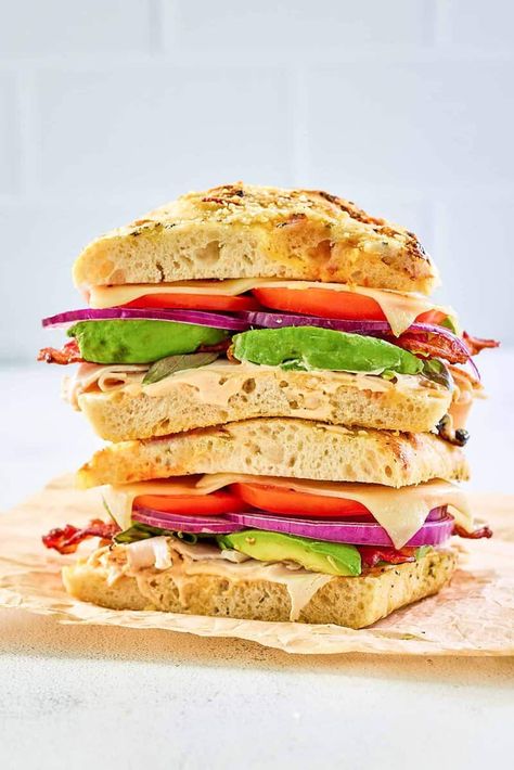 Panera Frontega Chicken Sandwich is great for lunch or dinner. Get the easy copycat recipe to make this tasty sandwich at home. Black pepper focaccia bread filled with smoked chicken, bacon, avocado, mozzarella cheese, tomato, onion, and chipotle sauce is a delicious and hearty meal. Chicken Panini Sandwiches, Chicken Bacon Avocado, Panera Recipes, Chicken Dishes For Dinner, Easy Sandwich Recipes, Cheese Tomato, Bacon Avocado, Chicken Sandwich Recipes, Bacon Tomato