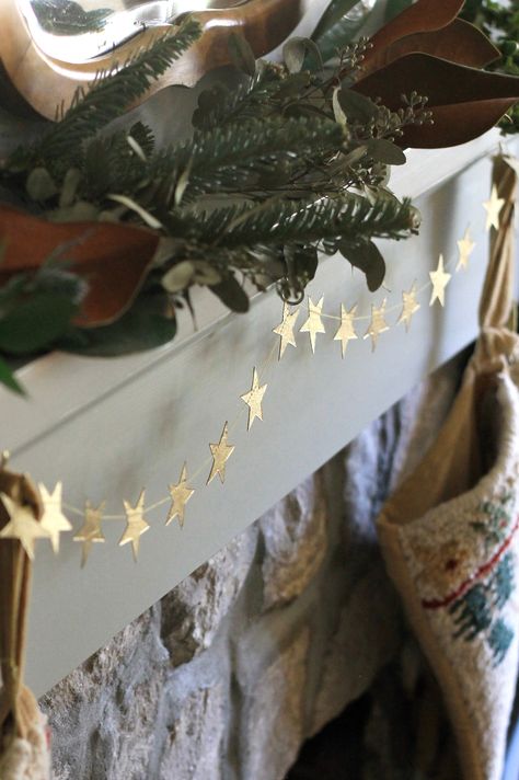 This is such a unique item. Handmade by women in Nepal of natural materials, a string of gold stars wrapped around a gift card with an envelope. Garland is 42" long. Green And Gold Holiday Decor, Wrapping Paper Garland, Homemade Star Ornaments, Gold Star Garland, Diy Christmas Garlands Ideas, Celestial Christmas Aesthetic, Cardboard Christmas Garland, Christmas Nature Decorations, Understated Christmas Decor