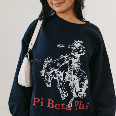 Navy crewneck, boyfriend fit. Our model is wearing size large (unisex). Size up for an oversized fit. 50% cotton, 50% polyester. Fraternity Letters Sweatshirts, Frat Merch Designs, Pi Phi Merch, College Merch Ideas, Cute Sorority Merch, Sorority Pr Shirts, Trendy Sorority Apparel, Pi Beta Phi Graphic, Sorority Merch Apparel Design