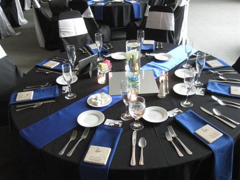 Royal Blue Satin Table Runner and Napkins accent the Black Table Linen, Black Chair Covers, and White Chair Sashes Black Chair Covers, Royal Blue Wedding Theme, Blue Table Settings, Satin Table Runner, Black Tablecloth, Corporate Event Planner, Wedding Table Linens, Blue Napkins, Royal Blue Wedding