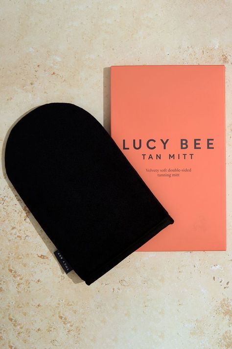 image of lucy bee self tanning mitt on a beige background with coral pink packaging Tanning Routine, Tanning Mitt, Self Tanners, Self Tanning, Fake Tan, Cardboard Packaging, How To Exfoliate Skin, Natural Tan, Tanning