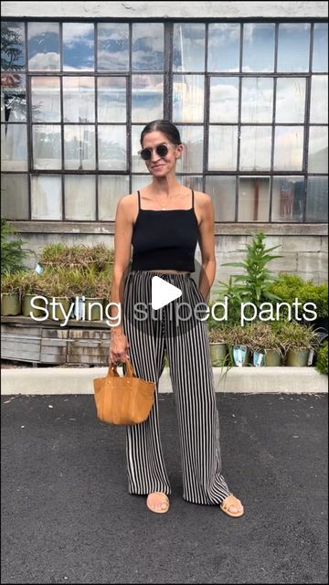 Dina Welz Jacobs on Instagram: "How to style striped pants! 🖤🤍😎  Picked up these cute striped pants on my latest trip and am loving them!  They are a neutral pant in my book and aren’t too busy or loud!  I was debating wearing these with either a button down shirt or tank top and decided on the tank.  The stripes add enough interest to the outfit so keeping the rest simple is important - it allows the pants to take center stage!  Do you own striped pants?  Comment 👇   Share this outfit idea with your stripe loving friend! 🫶  #stripes #stripedpants #flowypants #easystyle #easystyles #legitmomstyle #waystowear #styleideasdaily #over30style #over40style #microinfluencer #summeroutfitideas #momoutfit #momoutfits #blacktanktop" Shirt Over Tank Top Outfit, Striped Jeans Outfit, Style Striped Pants, Blue Pants Outfit, Neutral Pants, Tank Top Outfits, Flowy Pants, Too Busy, Striped Jeans