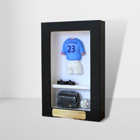 The Man City Treble Winners KitBox, from our 'Football Legends' range. A unique, hand-painted gift for football fans. Perfect presents for birthdays, Fathers & Mothers Day, Christmas & any other occasions. A painted resin figure and accessories housed in a wooden and glass frame.All our KitBoxes are hand-painted in our workshop in Surrey. Product Specifications: Frame size: 19cm x 12cm x 3.5cm Frame weight: 500g Man City Treble, Man City Football, Football Legends, Gifts For Football Fans, Painted Resin, Wall Accessories, Glass Frame, Man City, Football Fans