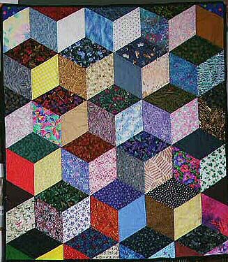 This interesting quilt is made with the tumbling blocks pattern. Underground Railroad Quilts, Quilt Design Wall, Tumbling Blocks Quilt, Optical Illusion Quilts, Colchas Quilting, Crazy Quilts Patterns, Tumbling Blocks, 3d Quilts, Block Quilt