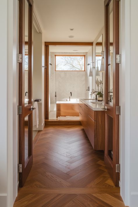 Luxurious bathroom with wooden accents, featuring a large bathtub, double sinks, and a window with natural light. Wood Floor And Tile Combinations, Cherry Wood Bathroom, Wood Flooring Bathroom, Teak Wood Flooring, Kitchen Flooring Trends, Kitchen Tile Inspiration, Wood Effect Floor Tiles, Ensuite Bathroom Designs, Wood Look Tile Floor