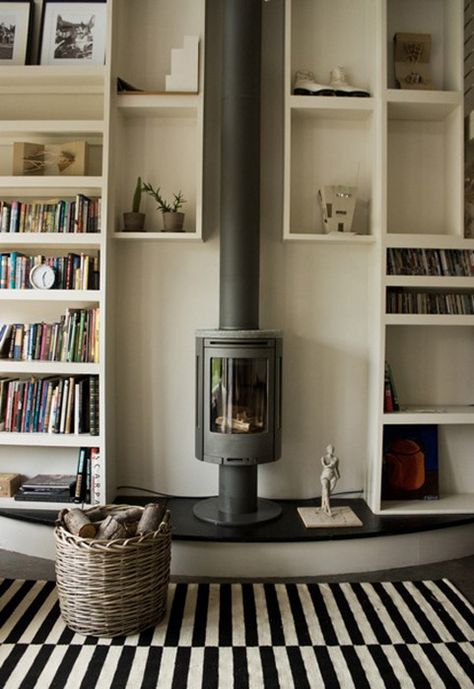 I like the contrast between the rug and the vertical fireplace with bookshelves on both sides. Wood Stove Decor, Contemporary Wood Burning Stoves, Stove Decor, Small Wood Burning Stove, Wood Burning Stoves Living Room, Modern Wood Burning Stoves, Fireplace Bookshelves, Wood Stove Fireplace, Freestanding Fireplace