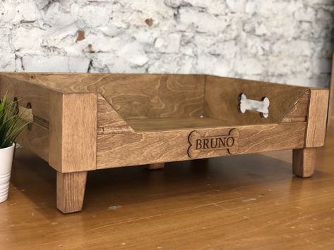 "Customizable Raised wooden dog bed is created for small and large pets. This elevated engraved dog bed will be a stylish decoration of your interior. * * DESCRIPTION * ➡️ Wooden bed materials: top quality plywood; 12 mm, 6 mm ➡️ Reinforced bottom, 8 mm ➡️ Legs are made of natural wood, height 3 inches (7 cm) ➡️Bed Color: brown, gray, dark brown * MORE * Modern dog bowls https://www.etsy.com/listing/1029845884 * SIZES * EXTRA SMALL (XS): fits for miniature dog breeds (Pekingese, Chihuahua, etc.)