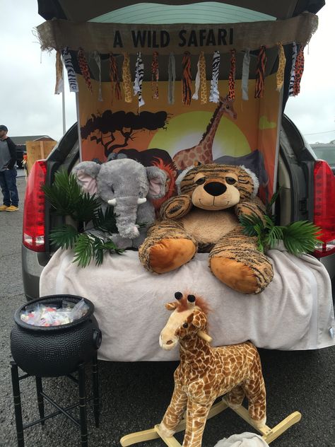 1 1/2 display boards taped and glued together covered with an African animal backdrop.  Add plush animals, plants, and banner of burlap ribbon with torn fabrics strips. Safari Trunk Or Treat Ideas For Cars, Safari Trunk Or Treat Ideas, Lion Outfit, Trunk Or Treat Ideas, Display Boards, Trunk Or Treat, Jungle Safari, Halloween 2024, Burlap Ribbon