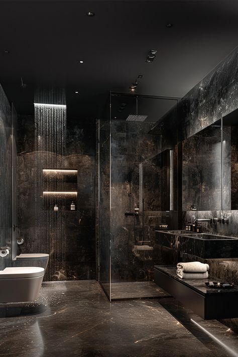 Luxurious Black Marble Bathroom • This stunning bathroom features sleek black marble walls and floors for an ultra-luxe look. • A rainfall showerhead offers a spa-like experience, perfectly complemented by built-in shelves with soft lighting. • The minimalist white bathtub contrasts beautifully with the dark tones, adding a touch of elegance. • Glass partitions and floating vanity keep the space modern and airy. • Subtle LED lighting highlights the rich marble textures Ultra Luxury Bathrooms, Luxury Black Bathroom Design, Rich Bathroom Aesthetic, Rich Modern Bathroom, Bathroom With Black Marble Floor, Dark Luxurious Bathroom, Dark Wetroom, Black And White Marble Bathroom Ideas, Dark Elegant Bathroom