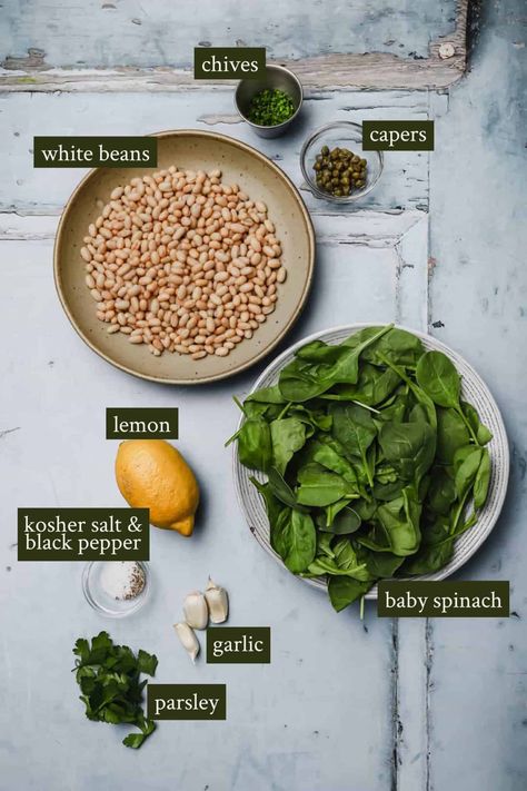 Garlic spinach with white beans is a healthy and nutritious side dish that pairs well with any number of entrées, from rotisserie chicken to seared salmon. Sautéed spinach is seasoned with garlic and small canned white beans, then flavored with fresh lemon juice and finely chopped herbs and capers. A vegetable side that is filling and flavorful! Whole30, V #wellseasonedstudio #garlicspinach #sautéedspinach #whitebeans #garlic #spinach Sauteed White Beans, White Bean Recipes, Diet Soup Recipes, Garlic Spinach, Pork N Beans, Northern Beans, Seared Salmon, Great Northern Beans, Sauteed Spinach